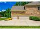 Spacious three-car garage with ample parking space and manicured landscaping enhancing curb appeal at 801 Hidden Pond Ln, Waxhaw, NC 28173