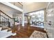 Open-concept living area with hardwood floors, stylish furniture, and seamless flow to the dining room at 801 Hidden Pond Ln, Waxhaw, NC 28173
