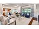 Spacious living room with hardwood floors, large windows, and comfortable furniture at 801 Hidden Pond Ln, Waxhaw, NC 28173