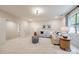 Bright and airy living room with comfortable seating, stylish decor, and ample natural light from the large window at 801 Hidden Pond Ln, Waxhaw, NC 28173