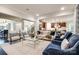 Open-concept living area connecting the kitchen, dining, and living spaces with hardwood floors at 801 Hidden Pond Ln, Waxhaw, NC 28173