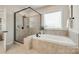 The main bathroom features a walk-in shower and a soaking tub at 801 Hidden Pond Ln, Waxhaw, NC 28173