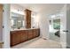 The main bathroom features double vanities, a large mirror, and wood cabinets at 801 Hidden Pond Ln, Waxhaw, NC 28173