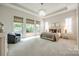 A spacious main bedroom features a tray ceiling, plush carpet, and plenty of natural light at 801 Hidden Pond Ln, Waxhaw, NC 28173