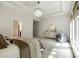 A luxurious main bedroom with a tray ceiling and a cozy seating area provides a serene retreat at 801 Hidden Pond Ln, Waxhaw, NC 28173