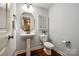 A stylish powder room with a pedestal sink and elegant fixtures offers a convenient and attractive space for guests at 801 Hidden Pond Ln, Waxhaw, NC 28173