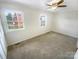 Inviting bedroom with neutral carpet, ceiling fan, and natural light from two windows at 8049 Regent Park Ln, Charlotte, NC 28210