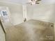Well-lit bedroom offers a ceiling fan, neutral carpet, and ample space at 8049 Regent Park Ln, Charlotte, NC 28210