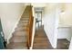 Welcoming entryway with staircase, hardwood floors, and adjacent powder room for added convenience at 8049 Regent Park Ln, Charlotte, NC 28210