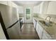 Efficient kitchen with stainless steel appliances, granite countertops, and bright white cabinetry at 8049 Regent Park Ln, Charlotte, NC 28210