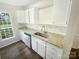 Well-lit kitchen features granite countertops, stainless steel sink, and bright white cabinets at 8049 Regent Park Ln, Charlotte, NC 28210