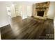 Open-concept living room boasts a stone fireplace and newer hardwood floors at 8049 Regent Park Ln, Charlotte, NC 28210