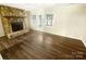 Bright living room with a cozy stone fireplace and hardwood flooring, providing a warm and inviting atmosphere at 8049 Regent Park Ln, Charlotte, NC 28210