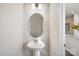 This powder room features a pedestal sink, modern mirror, and a clean, neutral color palette at 8118 Jacey Ln # 21, Huntersville, NC 28078