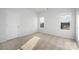 Bright bedroom with carpeted floors and ample natural light from the two windows at 8118 Jacey Ln # 21, Huntersville, NC 28078