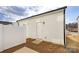 Back exterior of home featuring white siding, a white fence and manicured landscaping at 8118 Jacey Ln # 21, Huntersville, NC 28078