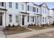 Attractive townhomes feature a clean white exterior and tidy landscaping, creating a welcoming curb appeal at 8118 Jacey Ln # 21, Huntersville, NC 28078