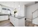 Bright kitchen with island featuring gray countertops, modern lighting and stainless steel appliances at 8118 Jacey Ln # 21, Huntersville, NC 28078