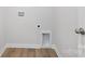 Bright laundry room featuring wood-look flooring and utility connections for modern convenience at 8118 Jacey Ln # 21, Huntersville, NC 28078