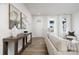 Bright living room is staged with cozy sofa, wood floors, neutral rug and elegant decor at 8118 Jacey Ln # 21, Huntersville, NC 28078