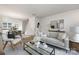 Open-concept living room with modern furnishings and hardwood floors, leading into dining area and kitchen at 8118 Jacey Ln # 21, Huntersville, NC 28078