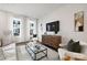 Bright living room features modern decor, a glass coffee table, and soft, natural lighting at 8118 Jacey Ln # 21, Huntersville, NC 28078