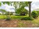 Large backyard with swing set and mature trees creating a shaded, serene setting at 819 Riddle Mill Rd, Clover, SC 29710