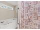 Bright bathroom featuring a jetted tub with a window view and a charming seashell-themed shower curtain at 819 Riddle Mill Rd, Clover, SC 29710