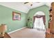 Charming bedroom with an arched window, green walls, and plush carpeting at 819 Riddle Mill Rd, Clover, SC 29710