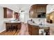 Open kitchen with an island, barstool seating, and hardwood floors throughout at 819 Riddle Mill Rd, Clover, SC 29710