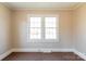 Well-lit room featuring carpet flooring and large windows at 819 W Rankin Ave, Gastonia, NC 28052