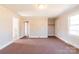 Neutral bedroom featuring carpet flooring and closet space at 819 W Rankin Ave, Gastonia, NC 28052