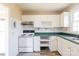 White kitchen with updated appliances and modern flooring at 819 W Rankin Ave, Gastonia, NC 28052