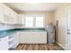 Bright kitchen with white cabinets, neutral countertops, and light wood floors at 819 W Rankin Ave, Gastonia, NC 28052