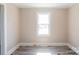 Sunlit room with neutral walls and vinyl flooring at 819 W Rankin Ave, Gastonia, NC 28052