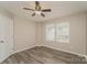 This cozy bedroom boasts natural light with luxury vinyl plank flooring and a ceiling fan at 838 Von Buren Blvd, Rock Hill, SC 29730