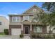Charming two-story home featuring brick and siding, a front porch, and an attached garage at 838 Von Buren Blvd, Rock Hill, SC 29730