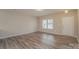 A bright living room with neutral paint, updated floors, and a door leading to the outside at 838 Von Buren Blvd, Rock Hill, SC 29730