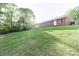 Large backyard with lush lawn and shade trees, perfect for outdoor activities and relaxation at 856 Skyline Dr, Chester, SC 29706