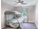 Carpeted bedroom featuring a bunk bed, ceiling fan, and window at 856 Skyline Dr, Chester, SC 29706
