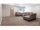 Cozy living room with neutral carpet, plush furniture, and natural light from the window at 856 Skyline Dr, Chester, SC 29706