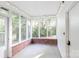 Bright sunroom with brick base, large windows and a view of the backyard foliage at 856 Skyline Dr, Chester, SC 29706