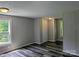 A bedroom features gray walls, new wood-style vinyl flooring, recessed lighting, and closet space at 874 Old Home Place Way, Lincolnton, NC 28092