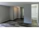 A bedroom featuring gray walls, new wood-style vinyl flooring, a closet, and an attached bathroom at 874 Old Home Place Way, Lincolnton, NC 28092