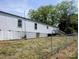 Home exterior featuring a grassy yard and chainlink fence at 874 Old Home Place Way, Lincolnton, NC 28092