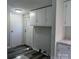 Kitchen area featuring white cabinets, a new granite countertop, modern lighting, gray walls, and wood-style vinyl flooring at 874 Old Home Place Way, Lincolnton, NC 28092
