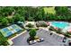 Aerial view of tennis courts and pool area with parking, landscaping, and outdoor seating and recreational areas at 9003 Smokey Hill Ln, Fort Mill, SC 29707