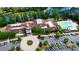 Aerial view of clubhouse with pool area, parking, well-manicured landscaping, and lake view in the background at 9003 Smokey Hill Ln, Fort Mill, SC 29707