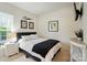 Comfortable bedroom with a full sized bed, natural light and simple decor at 9003 Smokey Hill Ln, Fort Mill, SC 29707