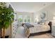 Cozy bedroom with large bed, neutral decor, and bright windows providing natural light and a view of the outdoors at 9003 Smokey Hill Ln, Fort Mill, SC 29707